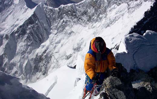 IMG climber topping out over the Hillary Step on his way to the summit of Mt. Everest. Photo by Dave Hahn.
