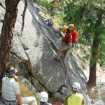 Instructor Olivia Race demonstrating a tandem lower - rappelling with an injured climber. (Photo by George Dunn) Instructor Olivia Race demonstrating a tandem lower - rappelling with an injured climber. (Photo by George Dunn)