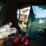 Owen catching up on some reading at the end of the day in one of the safari tents (Eben Reckord)