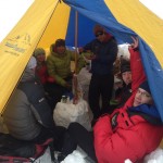 Group in the cook tent eating dinner Group in the cook tent eating dinner