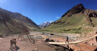 Aconcagua in the distance as the team crosses the first bridge